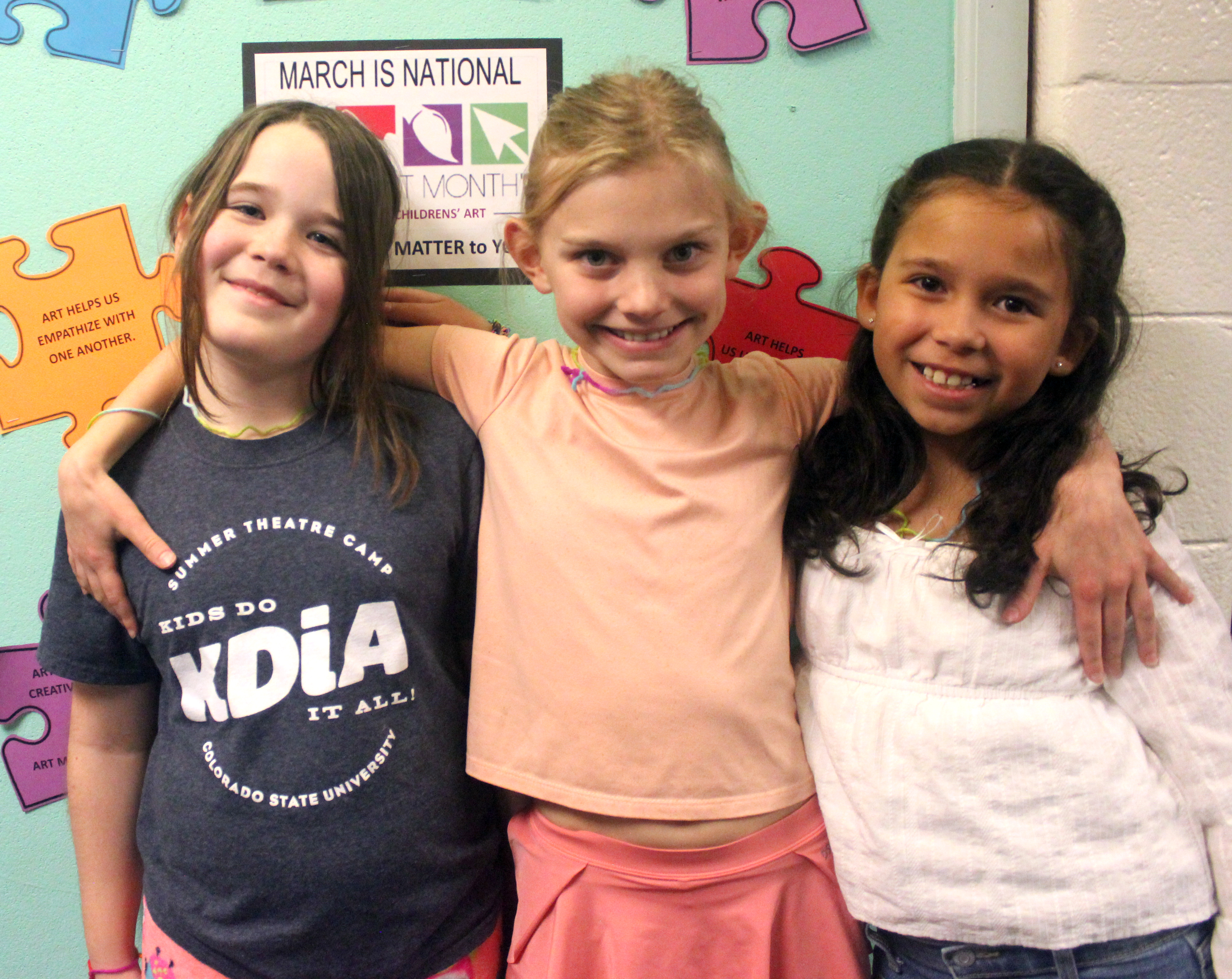 three girls with arms around shoulders - winners of grade 3 BOB competition