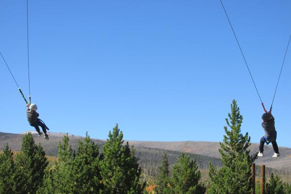 Two students doing the ropes course at Colorado State University's Mountain Campus during ECO Week.