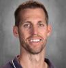 headshot - male teacher smiling short dark hair scruffy beaded chin