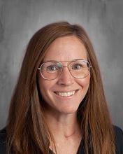 headshot - female teacher with long dark hair, glasses wearing a dark top