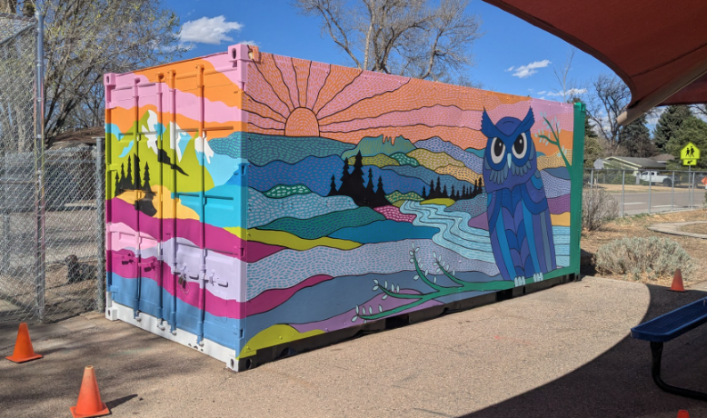 owl mural painted on a shipping container on the playground