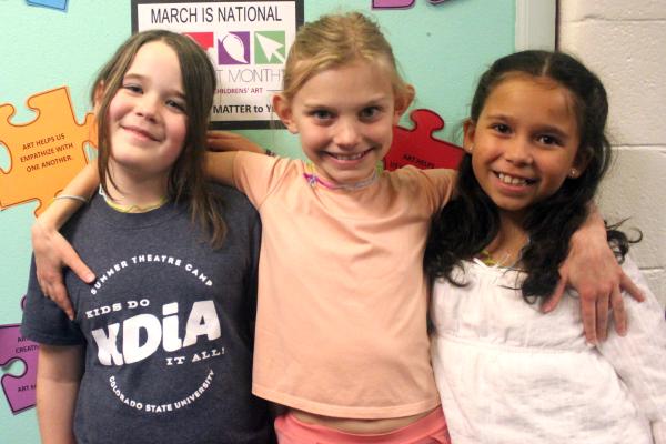 three smiling girls with arms around shoulders BoB in-buidling winners