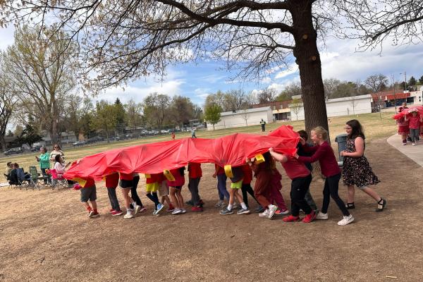 little second grade legs peeking out from under their red Chinese Dragon outside as they snaked around the playground