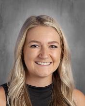 headshot - smiling female teachers with long light blonde hair wearing a black sleeveless top