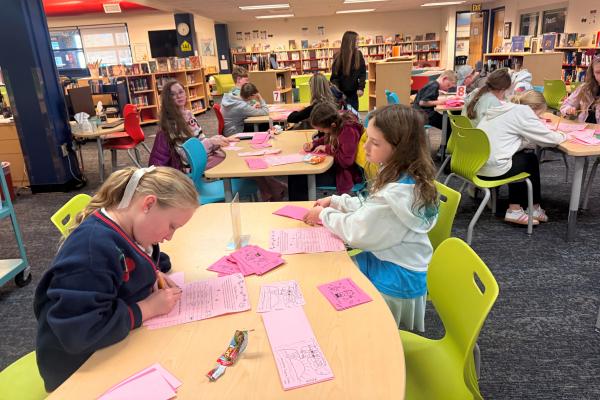 Student council students working on heart-o-grams in the library.