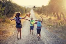 kids heading off down a dirt road to summer
