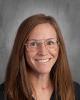 headshot - female teacher with long dark hair, glasses wearing a dark top