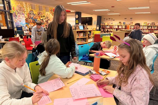 Student council students working on heart-o-grams in the library.